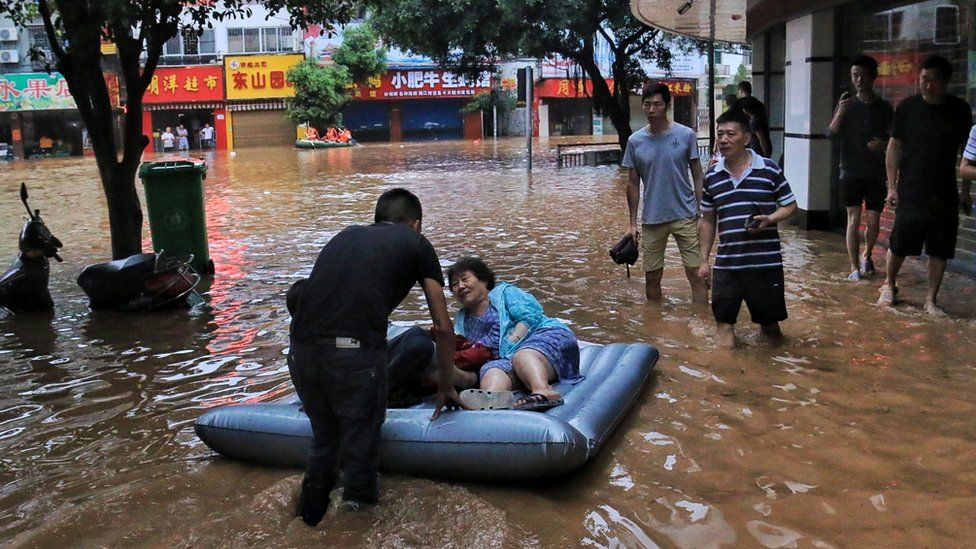 China floods 12 dead and thousands evacuated