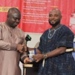 Larry Dogbey receiving the award from GJA President Albert Kwabena Dwomfour