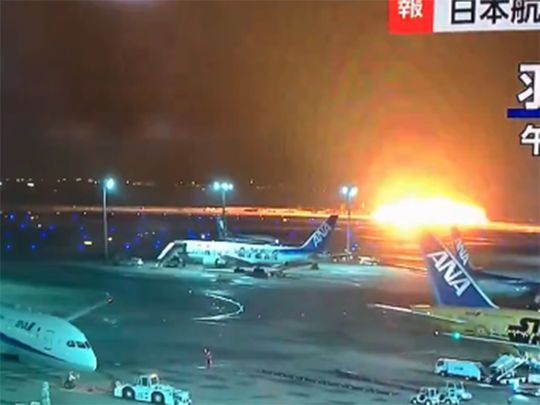 Japan Airlines plane in flames on the runway on Tokyo's Haneda Airport