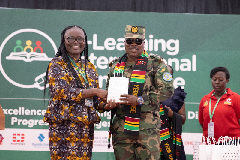 Prof Dickson presenting  package to Major General Gyane at the closing session of the conference.