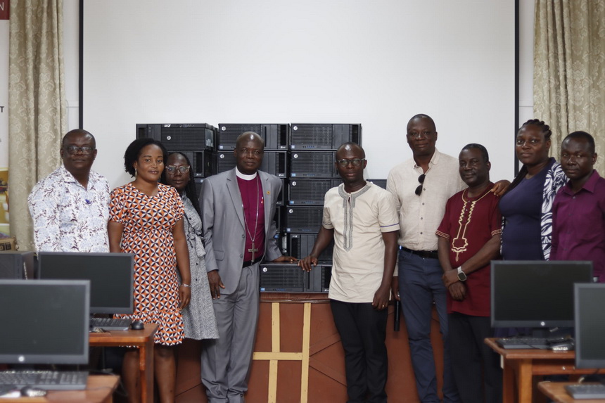 Mr. Baakoe and Right Reverend Andam pose with some staff and students by the donated computers